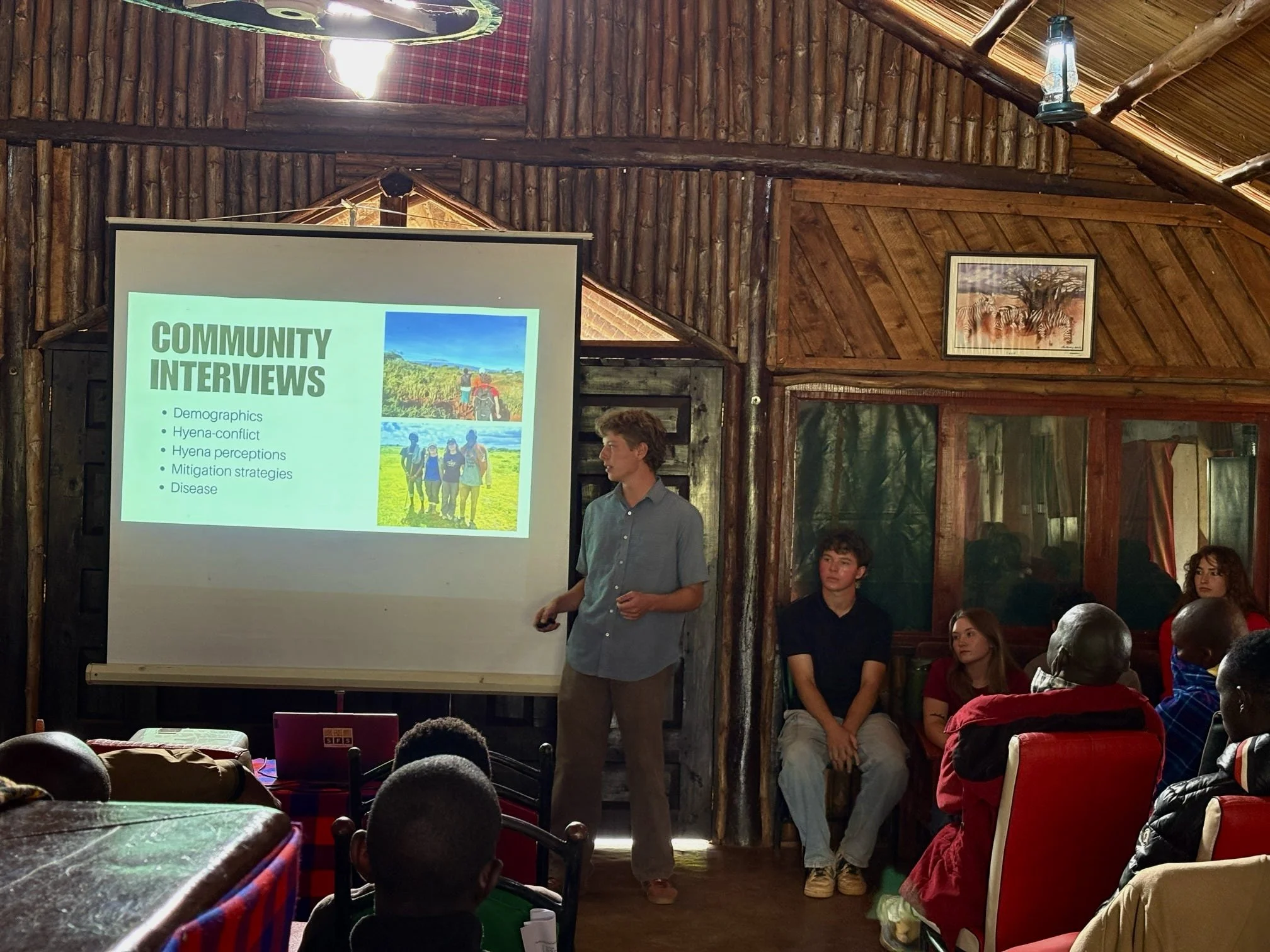 Steven is giving a presentation on human-hyena conflict research to a room of locals in Kenya.