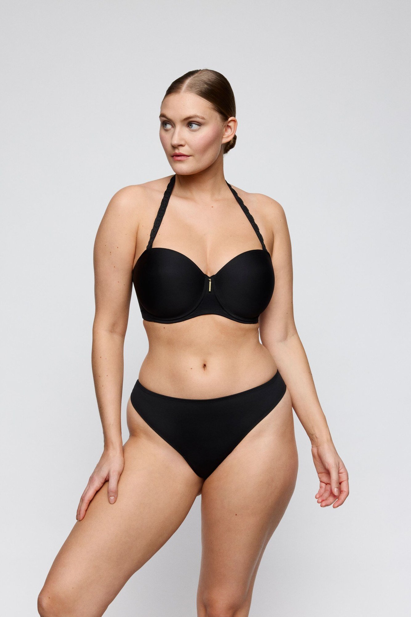 Black molded strapless bra worn with halter straps and matching brief