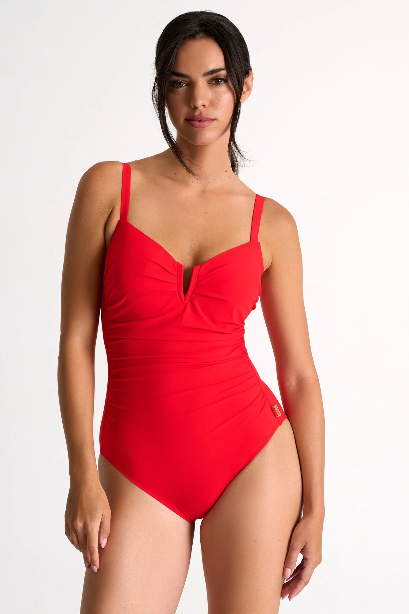 Red one-piece swimsuit with slim straps, worn