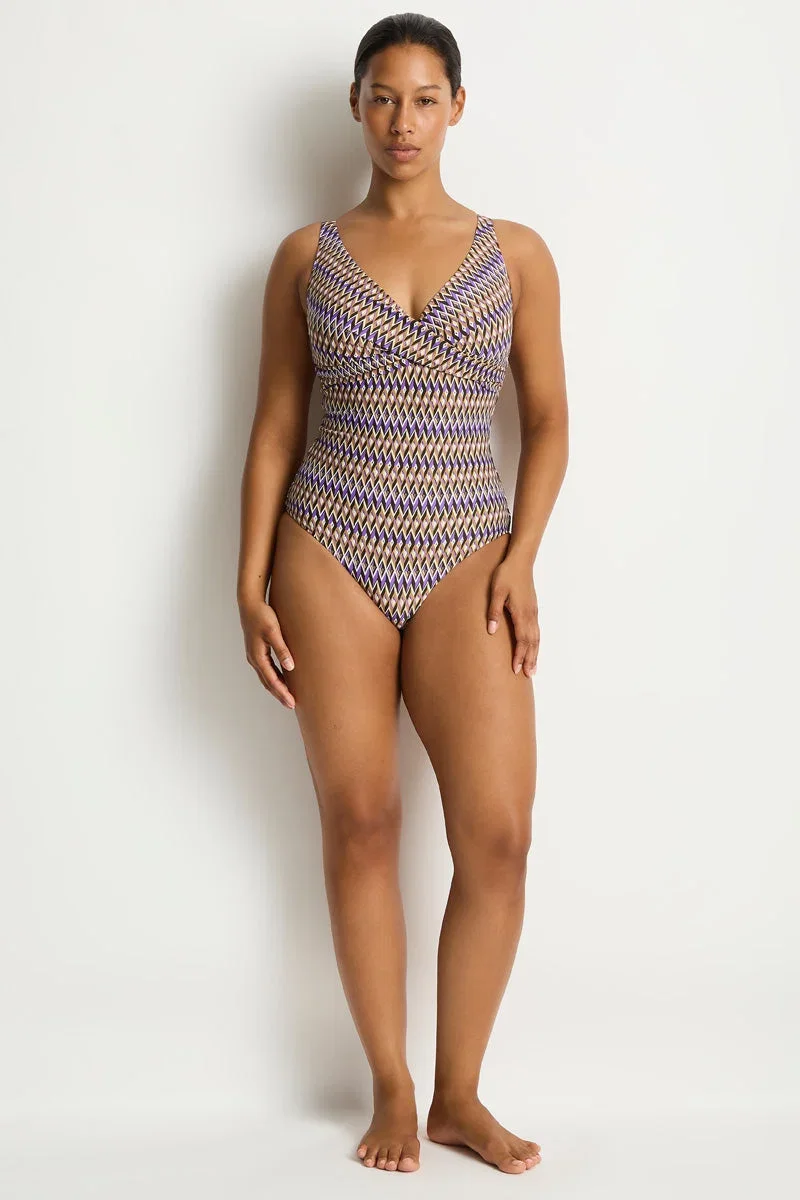 Cocoa and cream patterned cross-front one-piece swimsuit, worn
