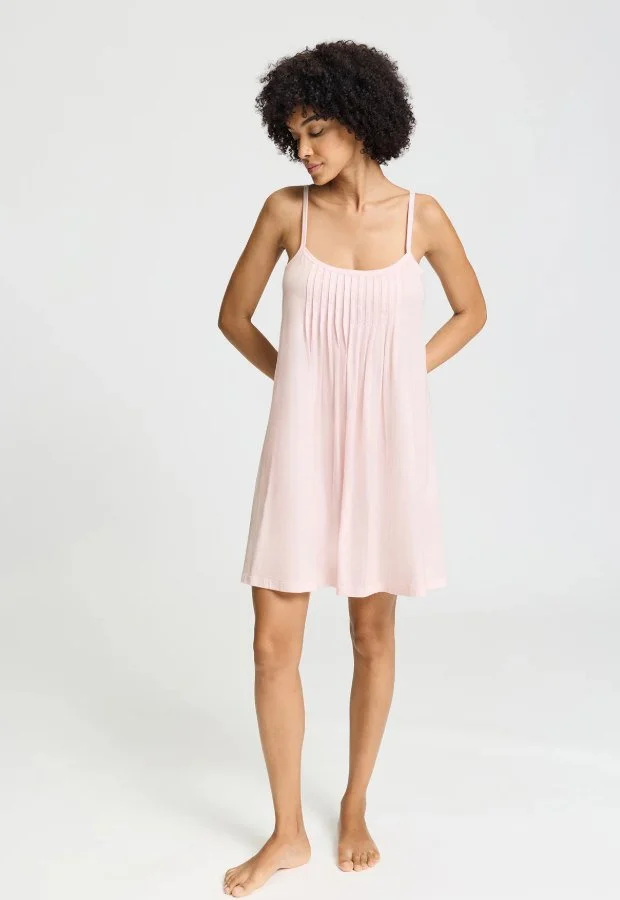 Model in a pale pink pintucked short nightgown with thin straps