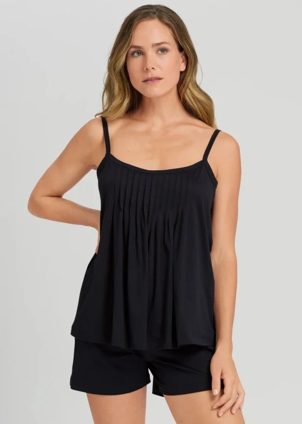 Model in a black pintucked camisole and shorts pajama set