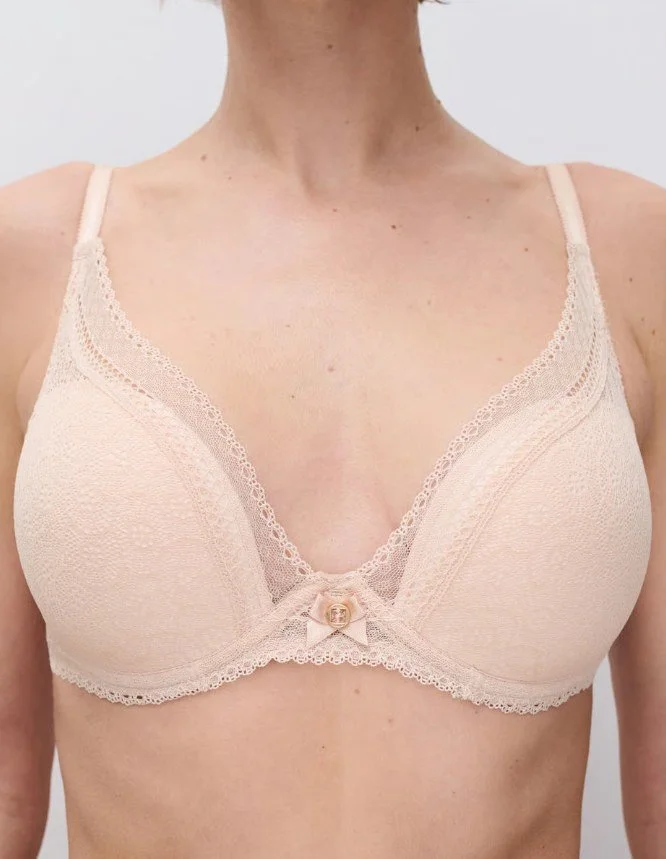 Nude lace plunge underwire bra with bow and charm, close-up