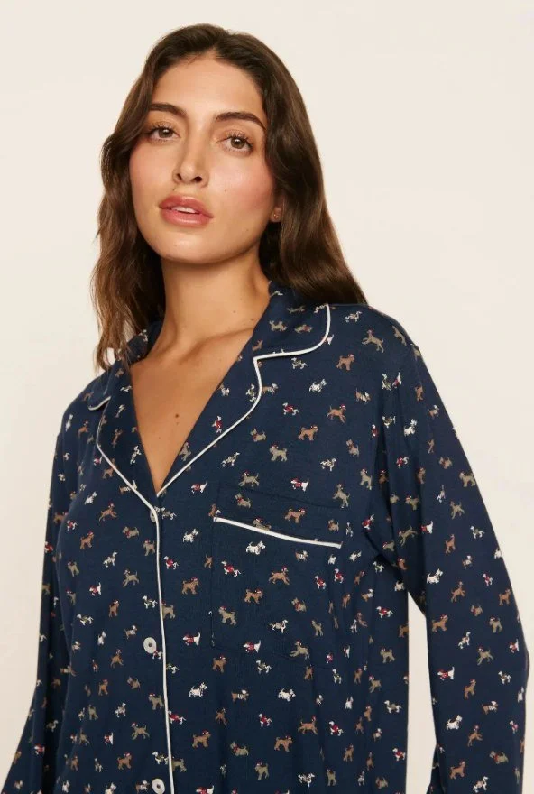 Close-up of a navy dog-print long-sleeve pajama top with white piping