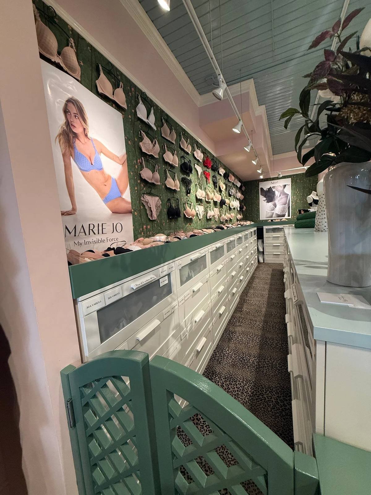 The bra wall at Chantilly Lace in Wilmette, with everyday bras on display above white drawers
