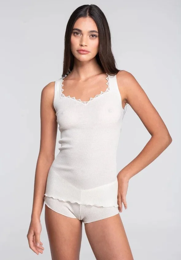 Model in an ivory ribbed tank with a scalloped lace neckline and matching shorts