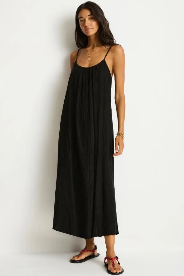 Model in a black sleeveless scoop-neck maxi sundress