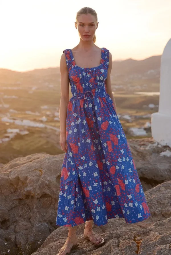 Model in a blue and red floral print maxi sundress at sunset