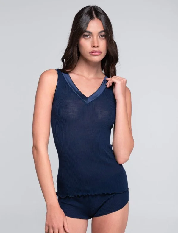 Model in a navy V-neck tank with satin trim and matching shorts