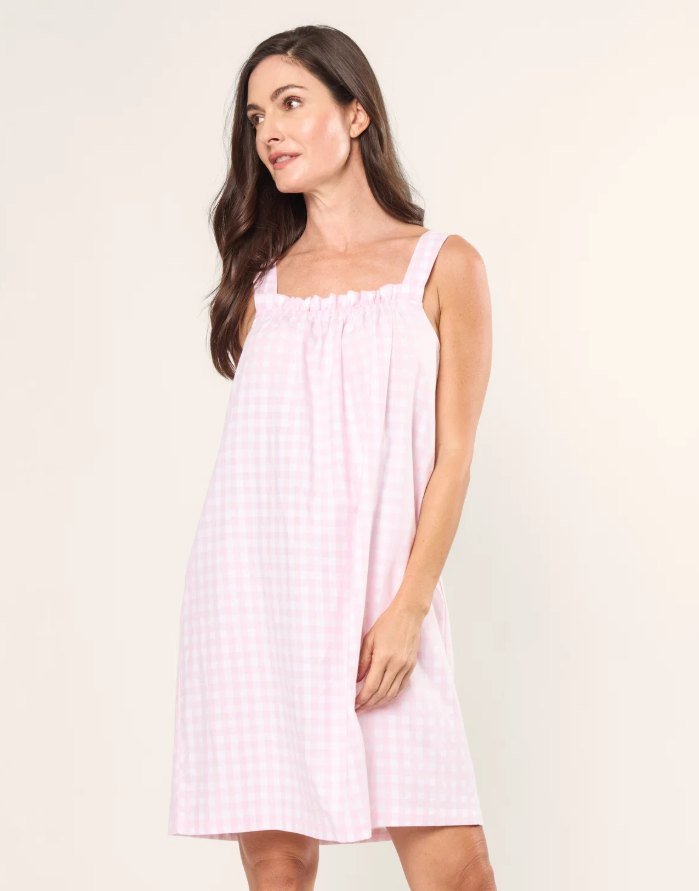 Model in a pink gingham sleeveless nightgown with a ruffled neckline