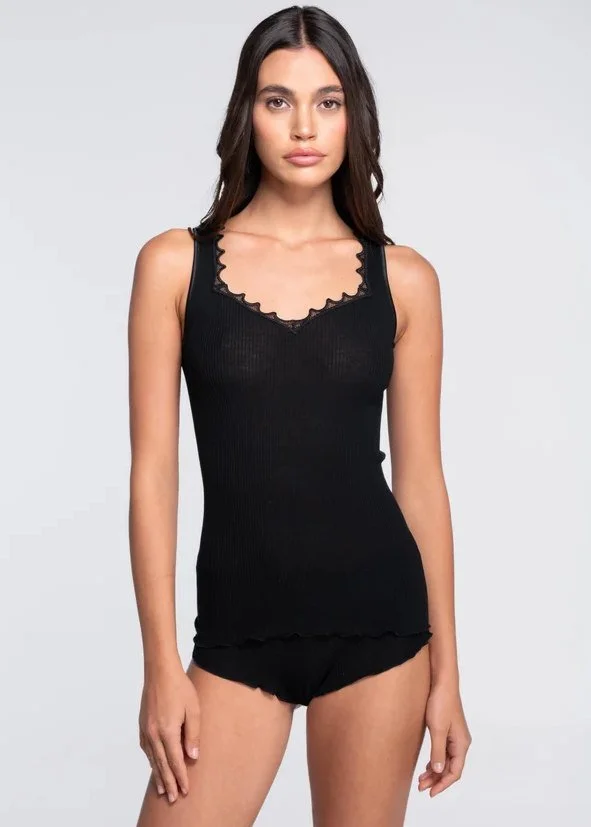 Model in a black ribbed tank with a scalloped lace neckline and matching shorts