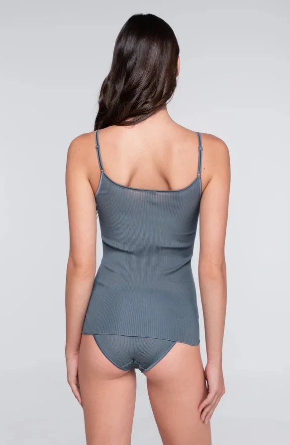 Back view of a model in a slate blue thin-strap camisole and matching brief