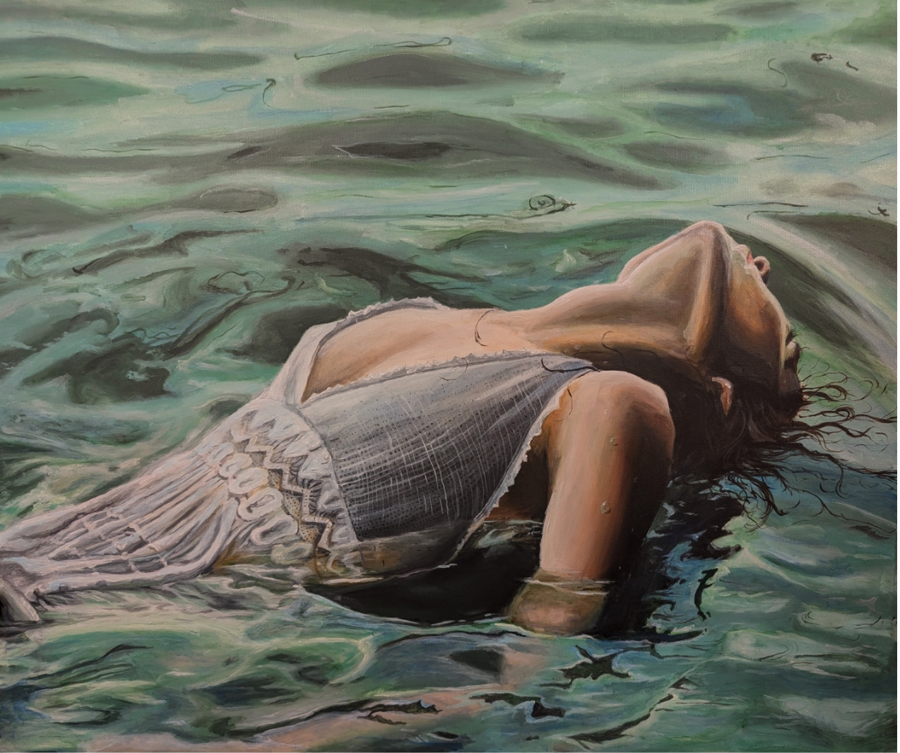 A woman lying in water with her eyes closed, wearing a patterned top and resting on her side.