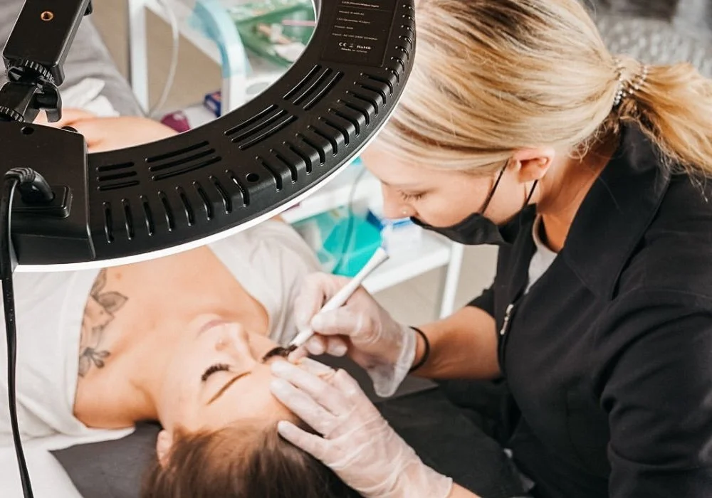 Brianna Errelat performing a brow treatment in the studio