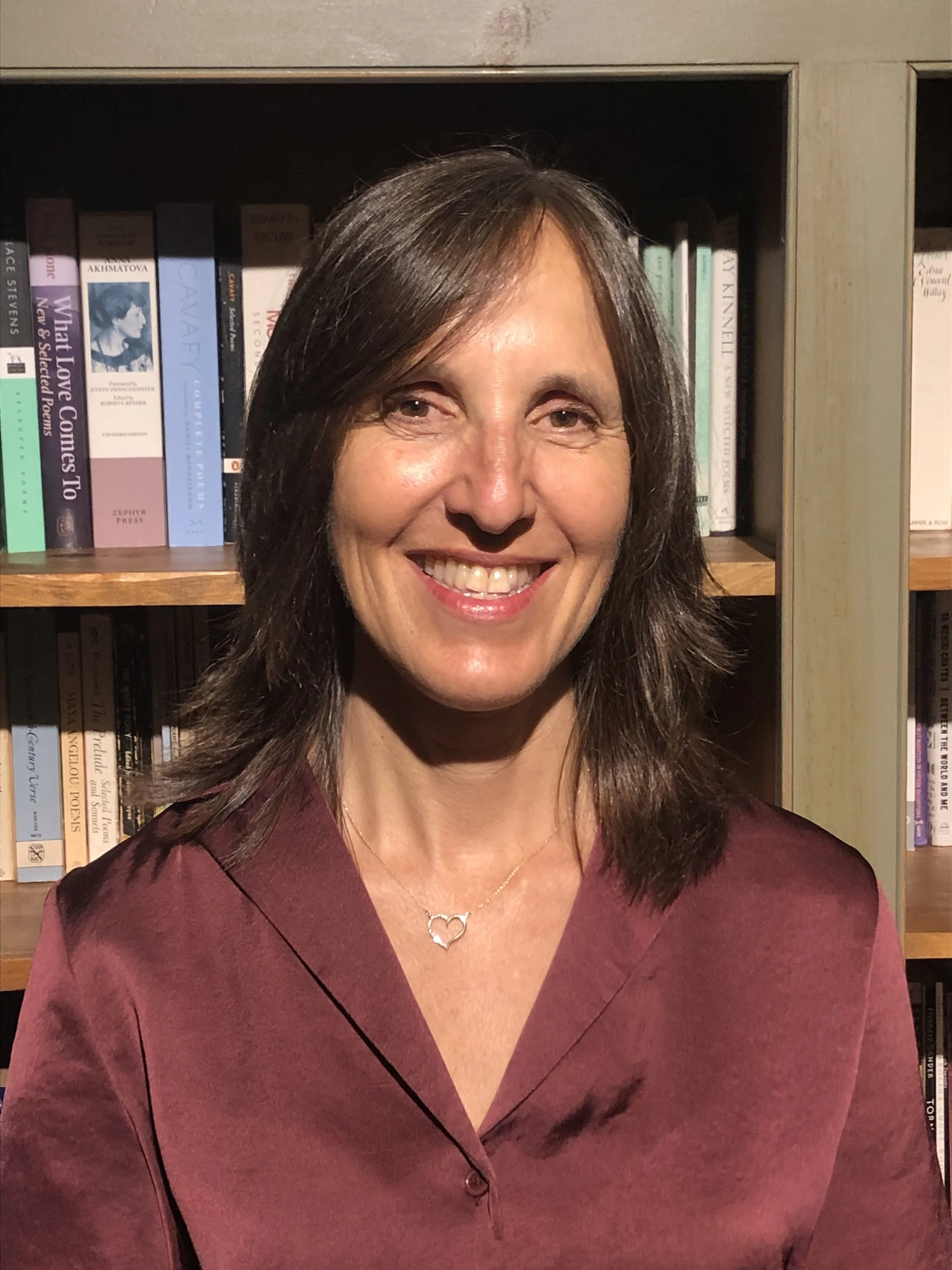 Marisol Kaminski, LCSW, psychotherapist in Mount Kisco, NY, smiling in front of a bookshelf