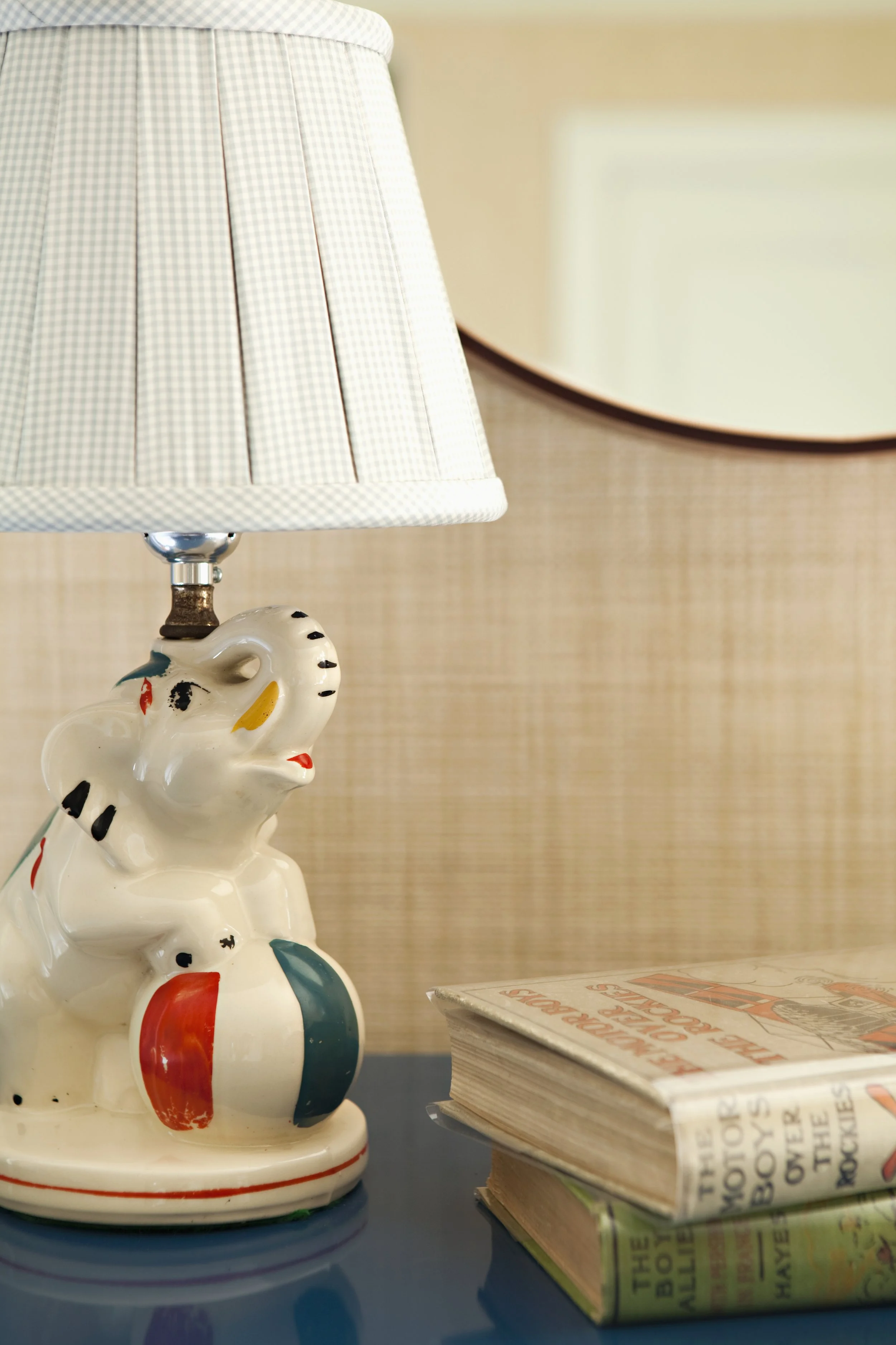 Elephant lamp against a grasscloth wall in a child's room