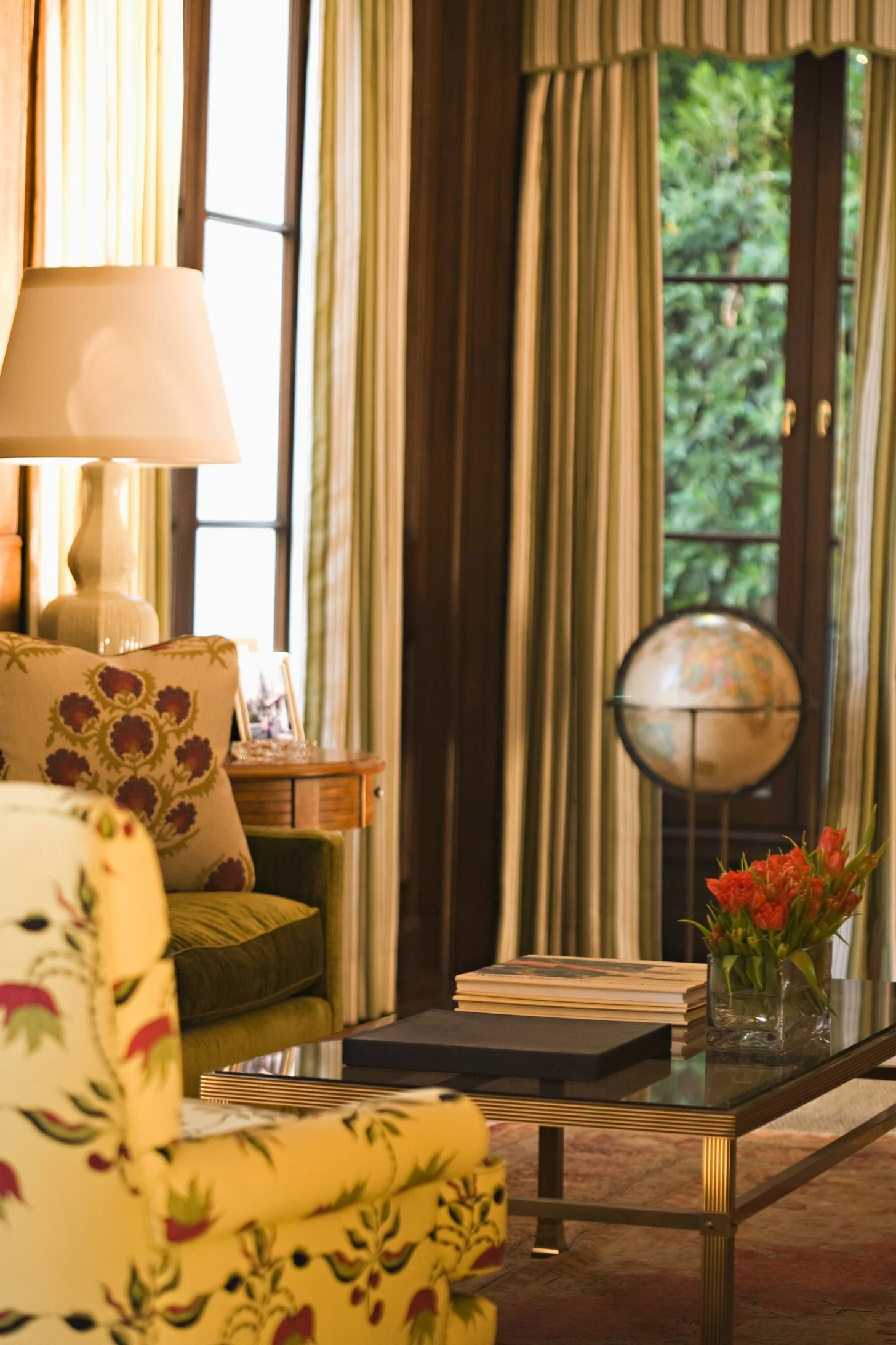 Study corner with striped curtains, a globe and floral pillows