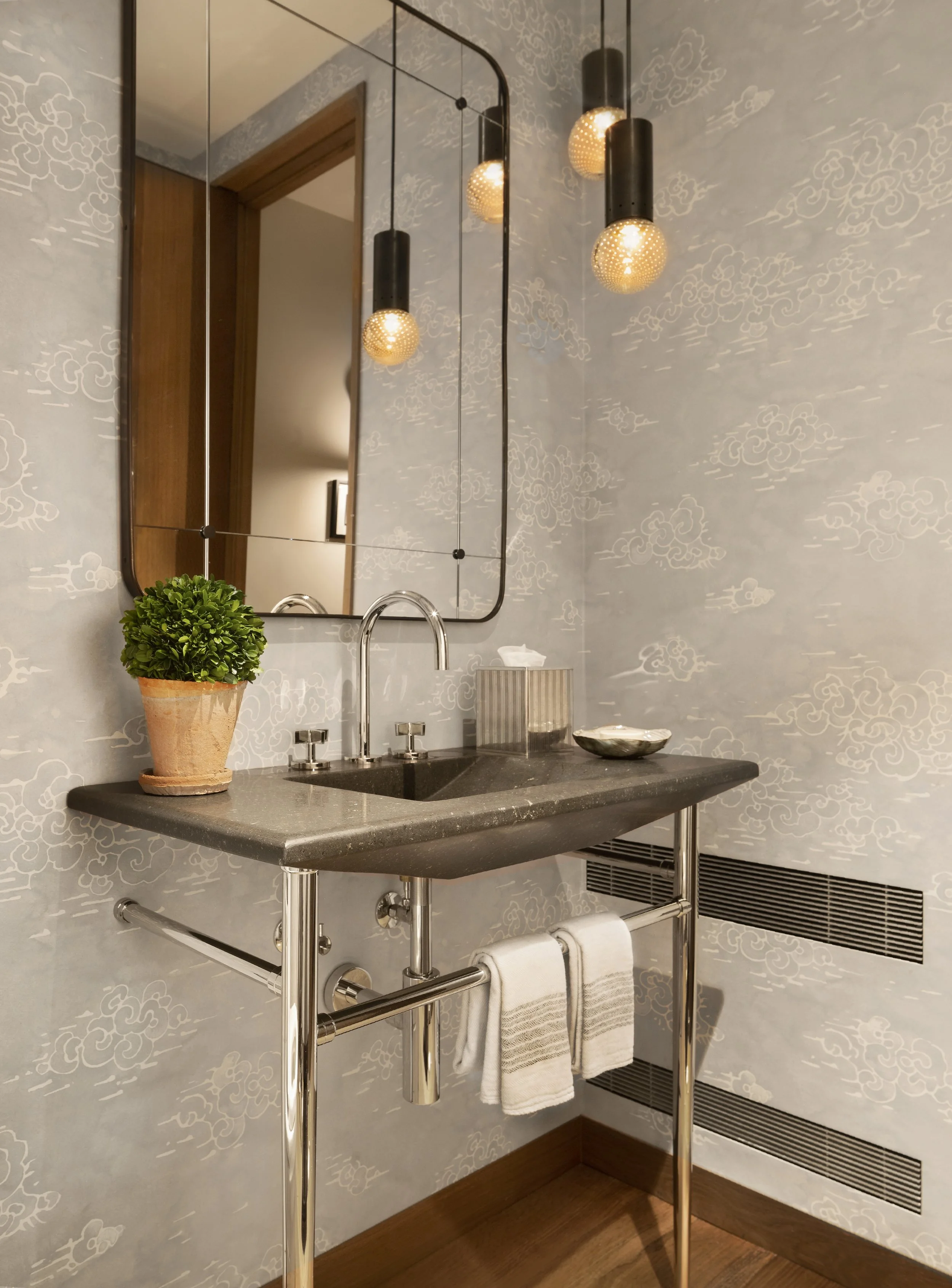 Powder room with cloud pattern wallpaper and a steel and stone vanity console