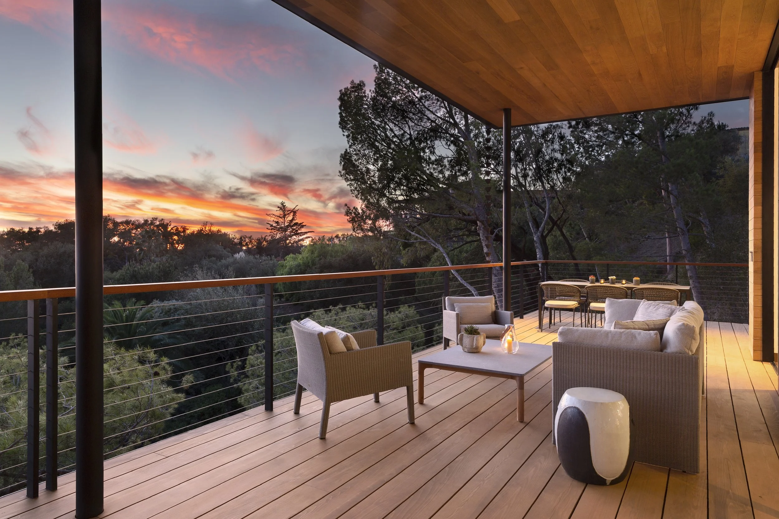 Terrace at sunset with outdoor seating, a fire table and a wood ceiling