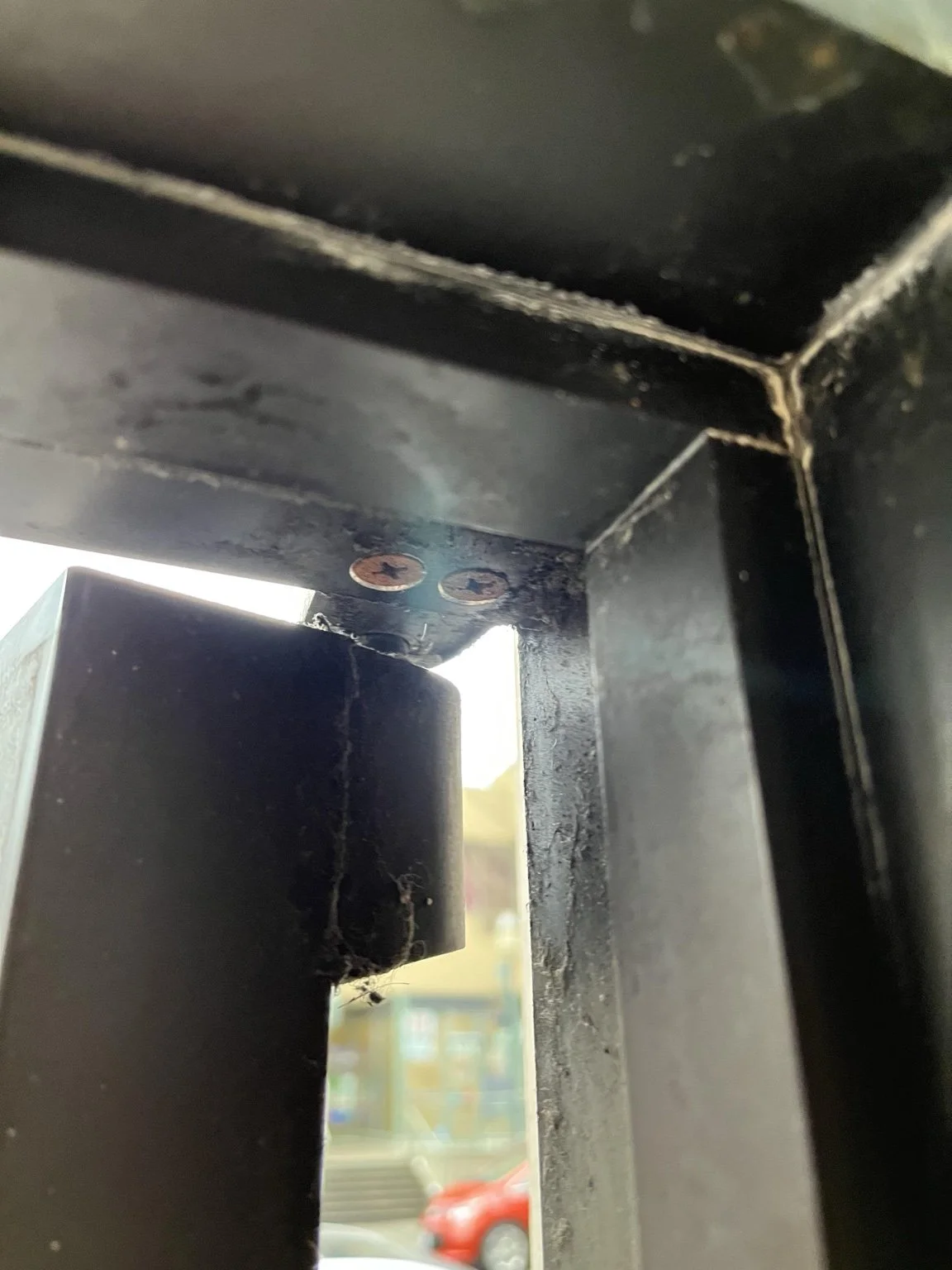 Damaged upper pivot hardware on a commercial door