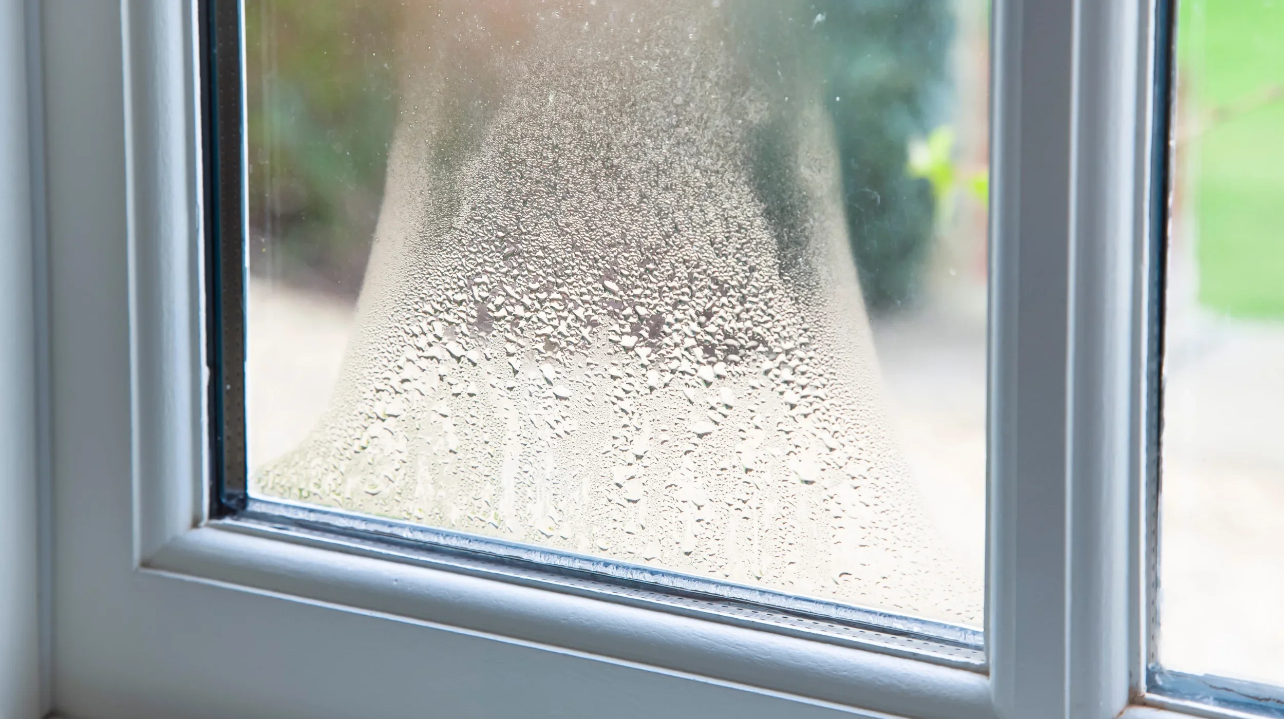 Cloudy insulated glass unit with condensation between panes