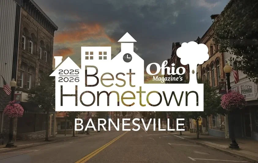 Overlay graphic celebrating Barnesville as Ohio's best hometown for 2025-2026, with stylized buildings, trees, and street scene background.