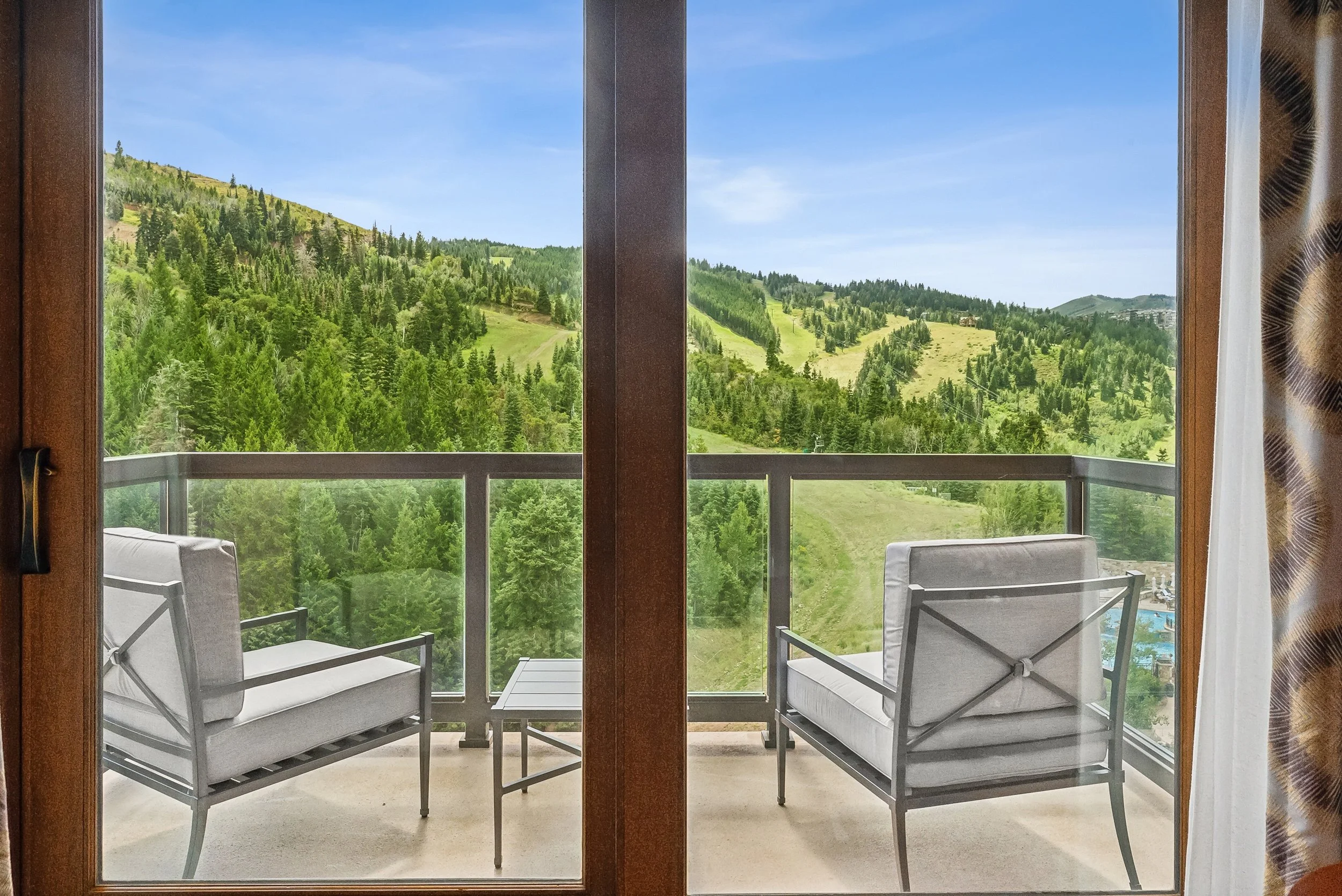 14-balcony-doors-opening-toward-green-mountain-slopes.jpg