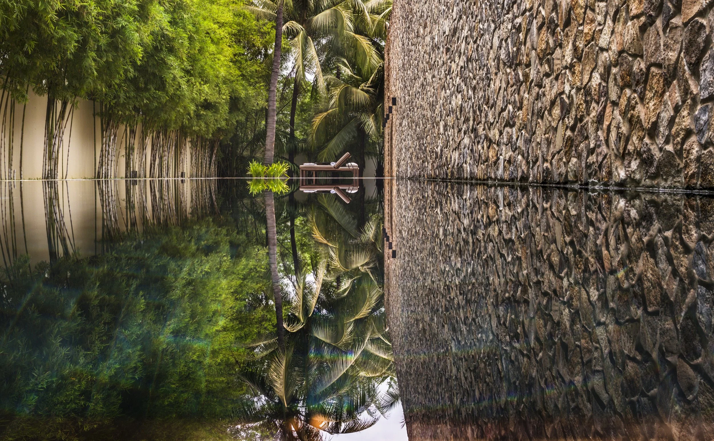 05-reflecting-water-and-stone-relief-beside-amansara-wellness-spaces.jpg