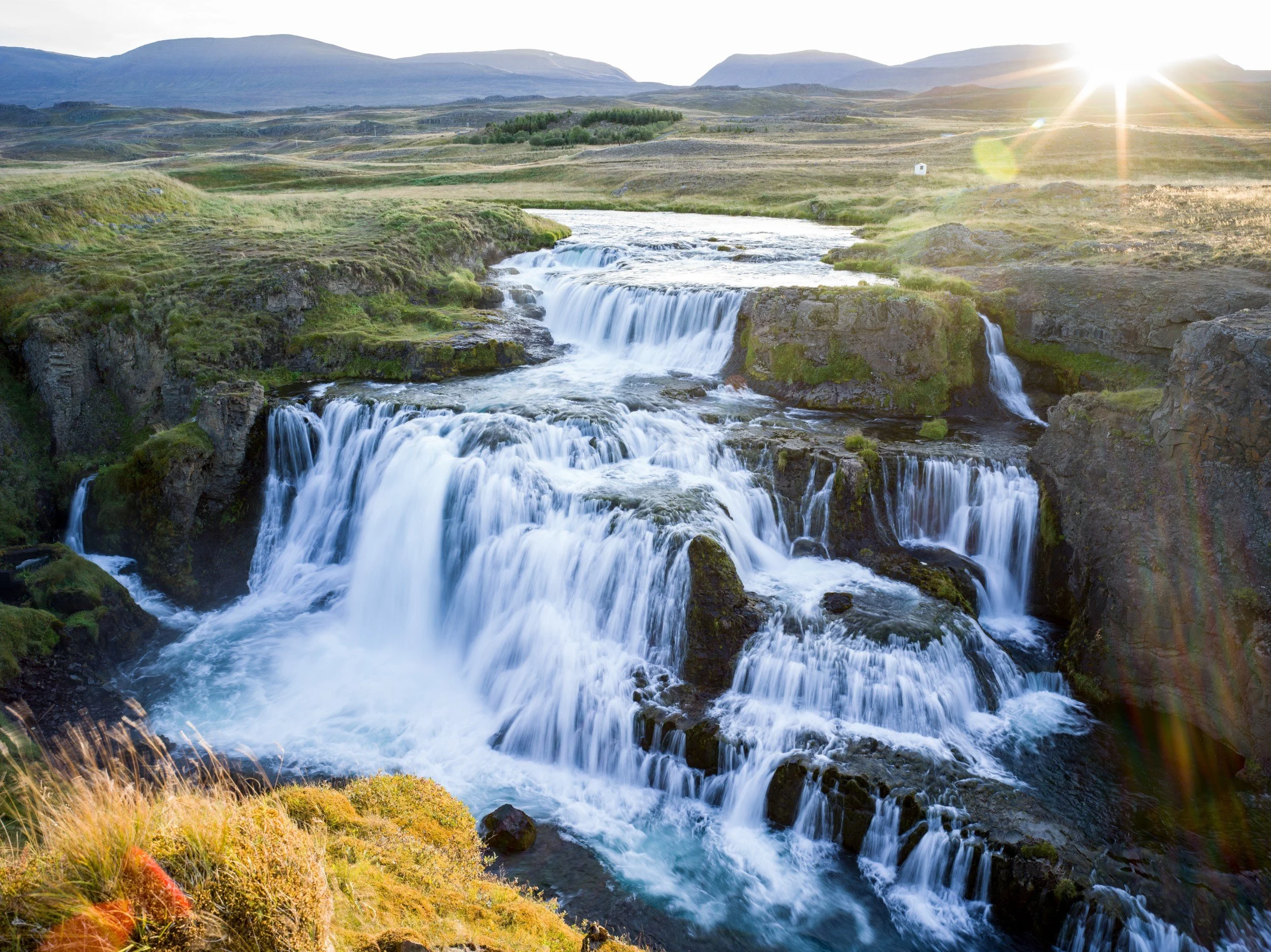 36-cascading-waterfall-and-green-landscape.jpg