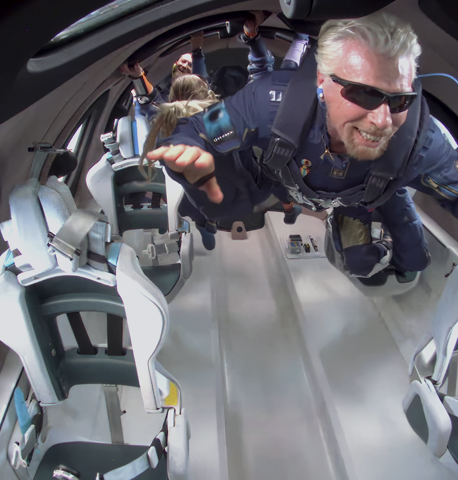 Skydiving instructor and tandem passengers inside an aircraft before a jump