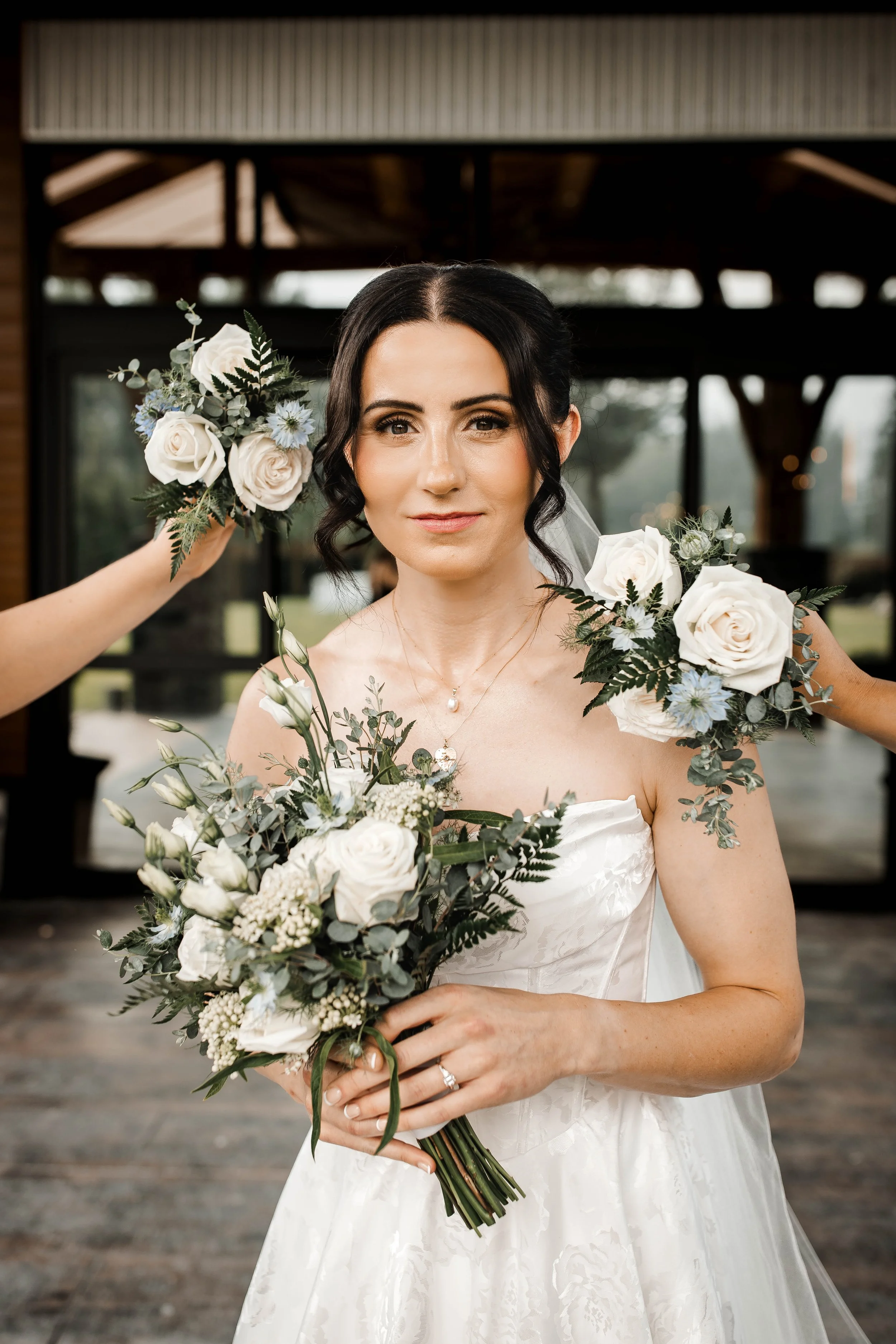 Romantic bridal portrait featuring a bride holding a white floral bouquet.