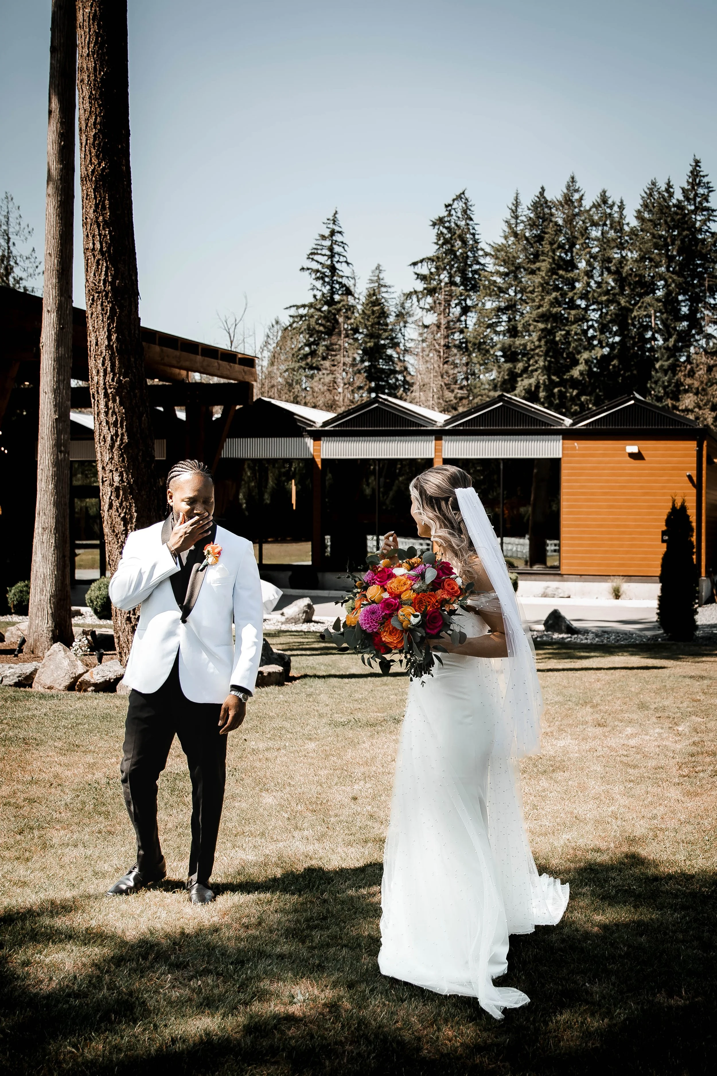 Groom smiling with surprise during a romantic outdoor first look at Bridlewoods wedding venue in the Fraser Valley.