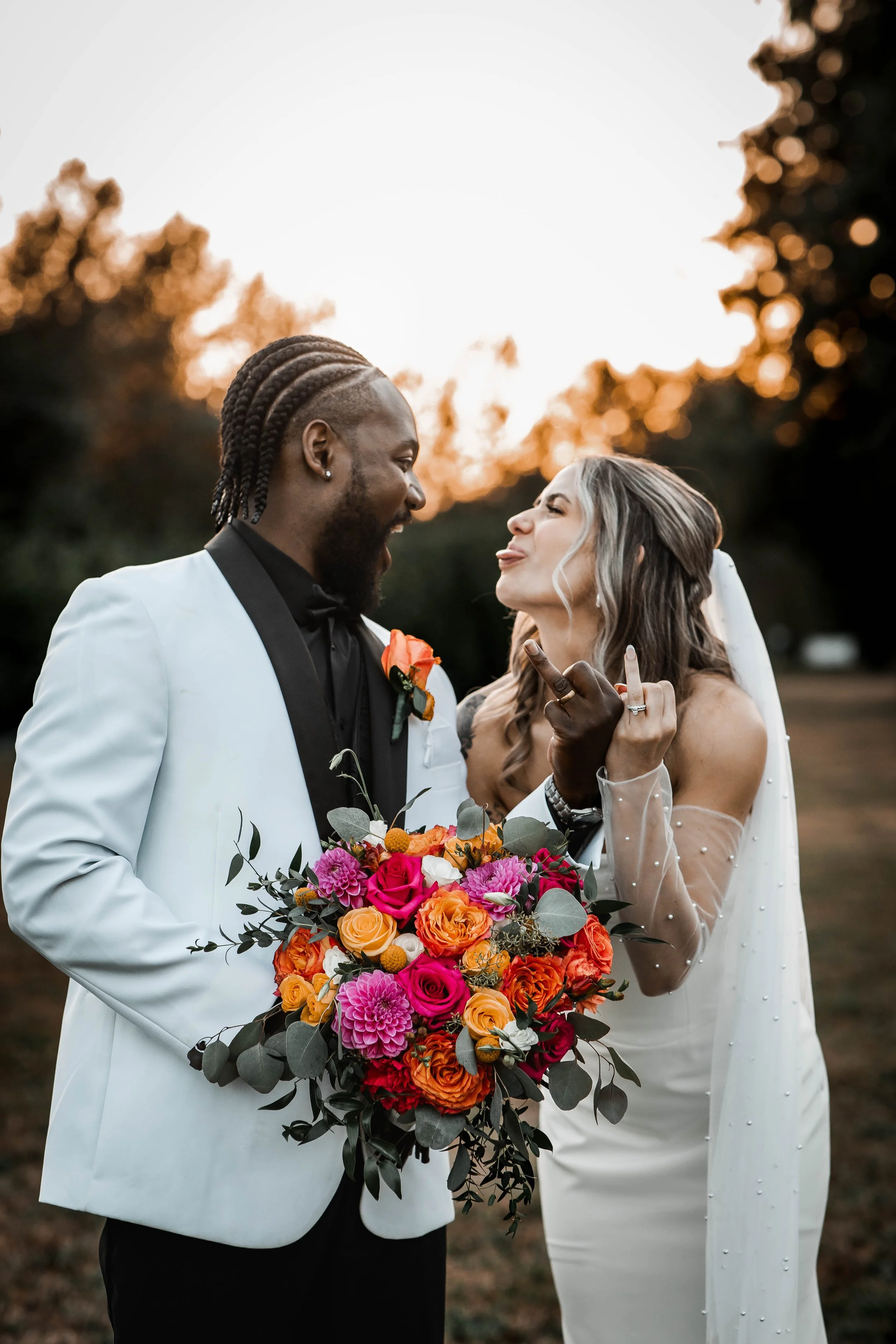 Bride and groom sharing a romantic golden-hour moment with a colourful wedding bouquet at Bridlewoods in Chilliwack, BC.