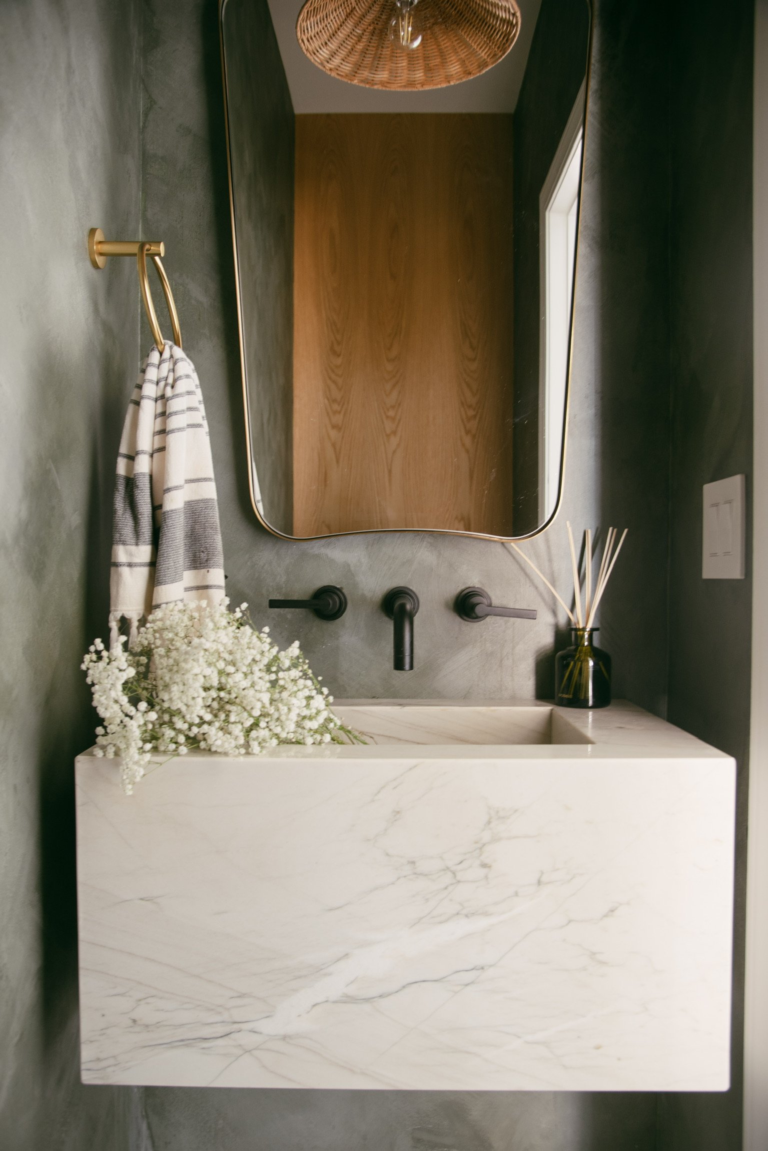 A Powder Room in Deep Green and Earthy Texture