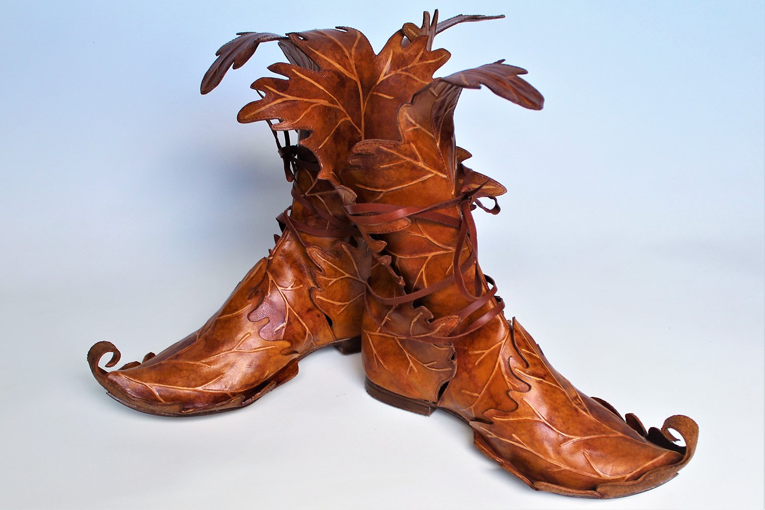 Leather boots designed to look like they are made of autumn leaves.