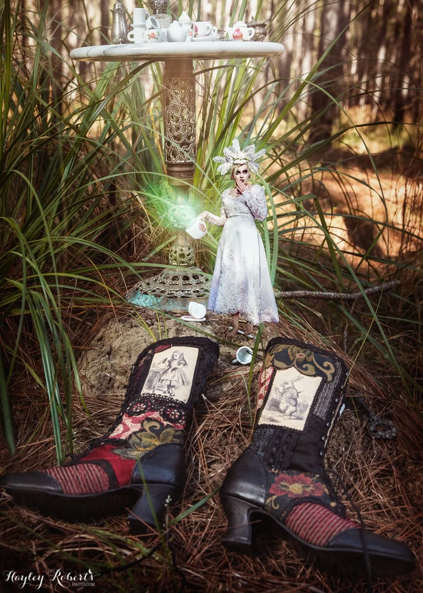 A magical photograph of a tiny fairy discovering a pair of Alice in Wonderland boots