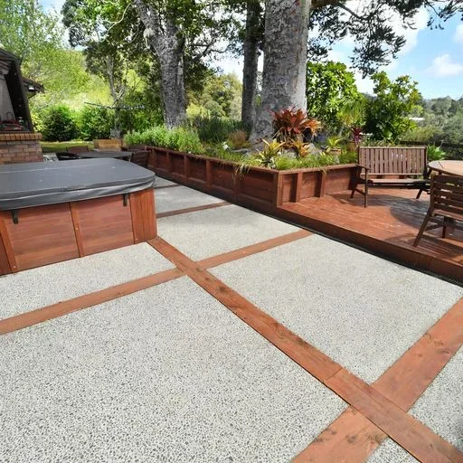 Exposed aggregate concrete patio beside timber decking