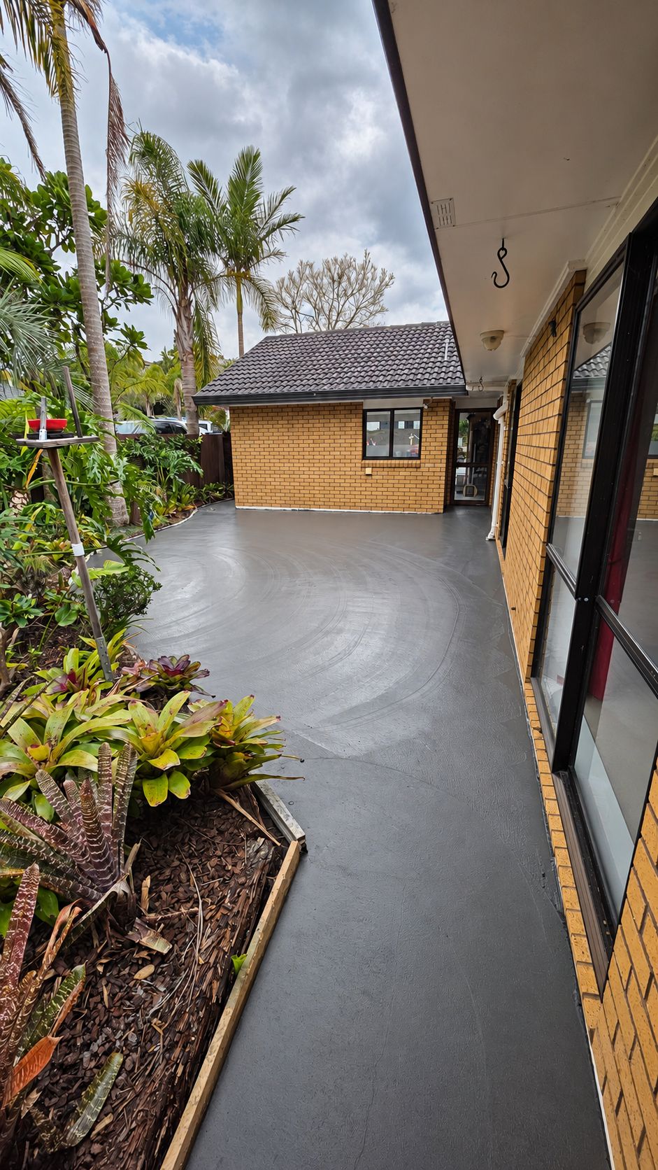 Pour stage: freshly placed and trowelled concrete before cutting and the later acid wash and sealing.