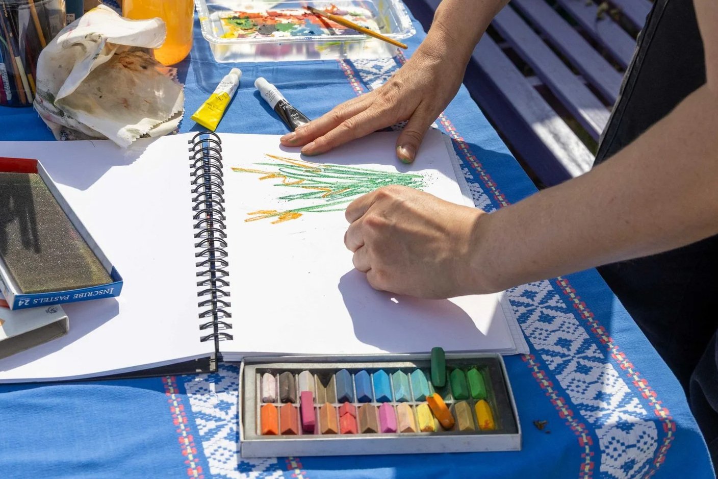 Someone sketching flowers at a table