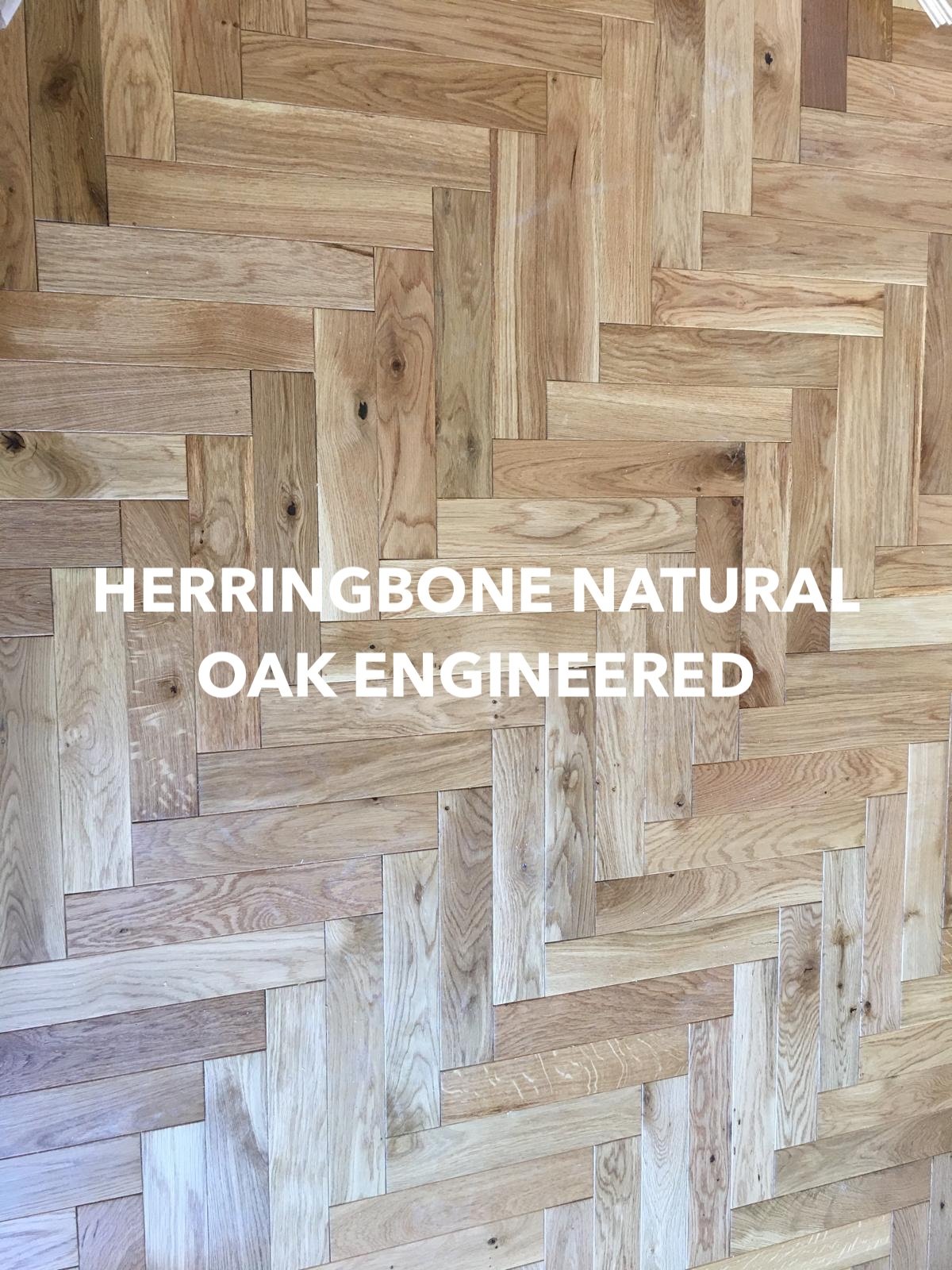 Close-up of natural oak engineered flooring laid in a herringbone pattern.