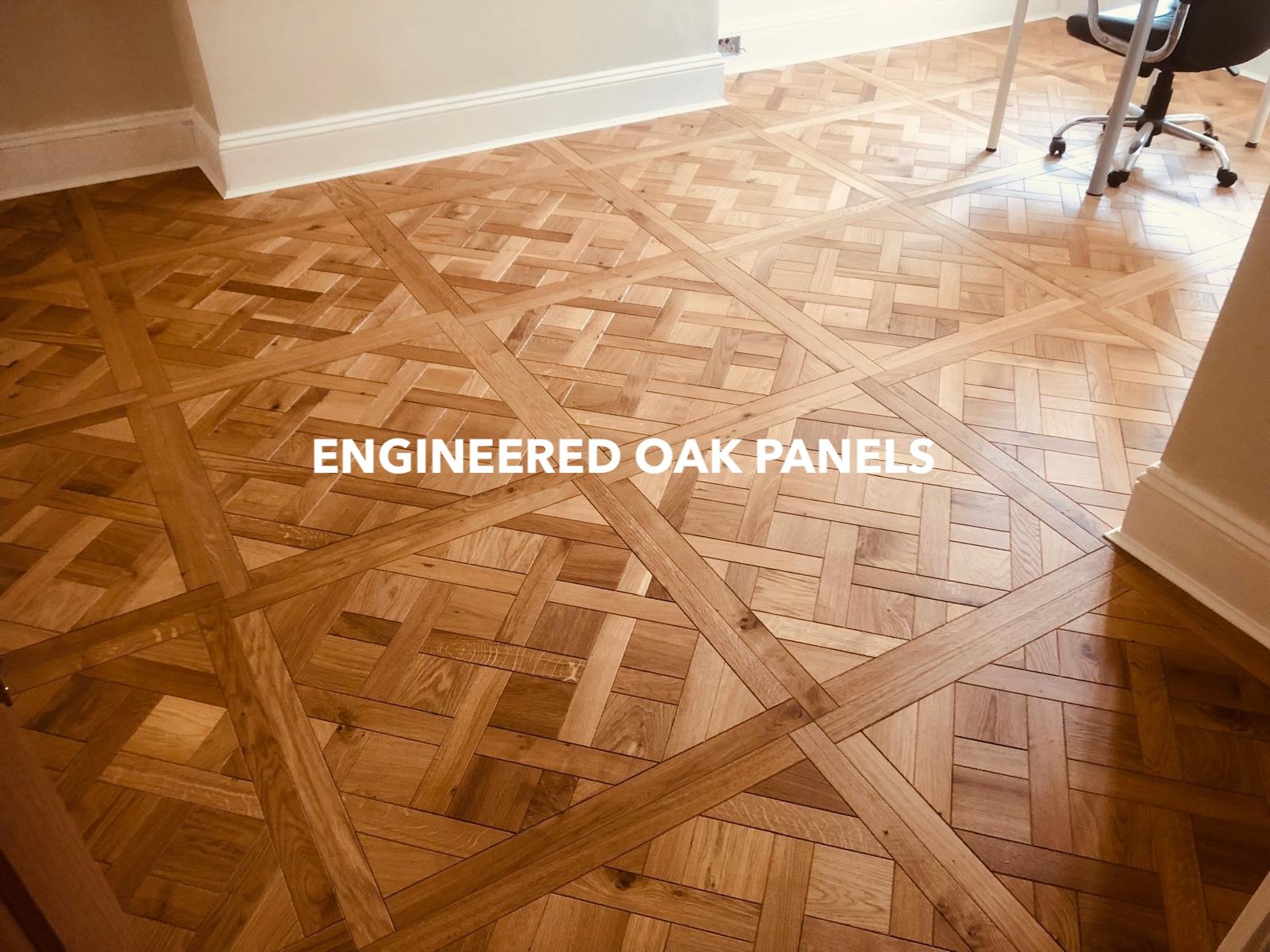 Geometric engineered oak floor panels in a furnished room.