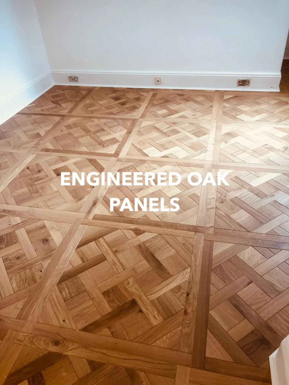 Geometric engineered oak floor panels in an empty room.