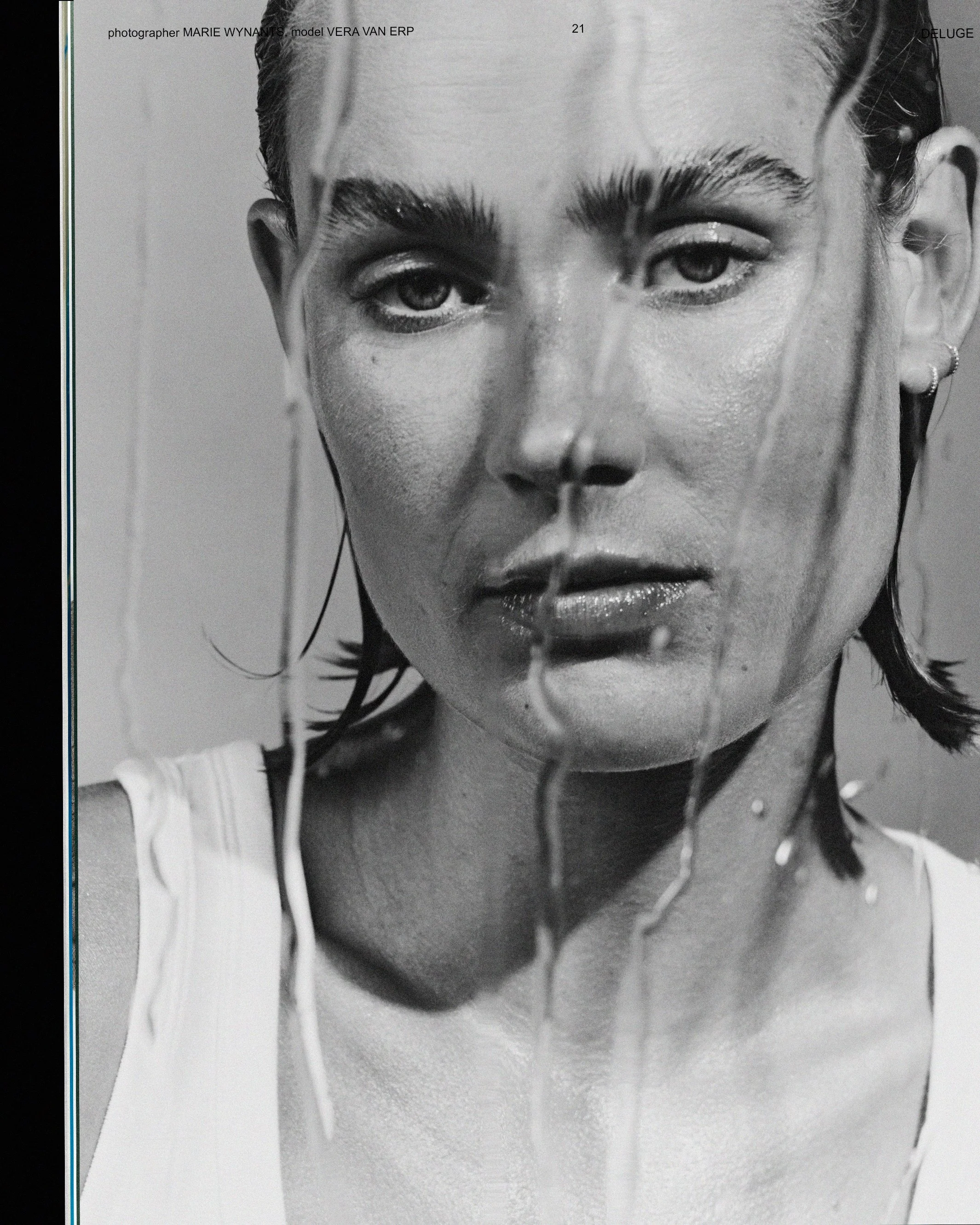Black and white close-up photograph of a woman's face, focusing on her eyes and lips, with her hair wet and slicked back.