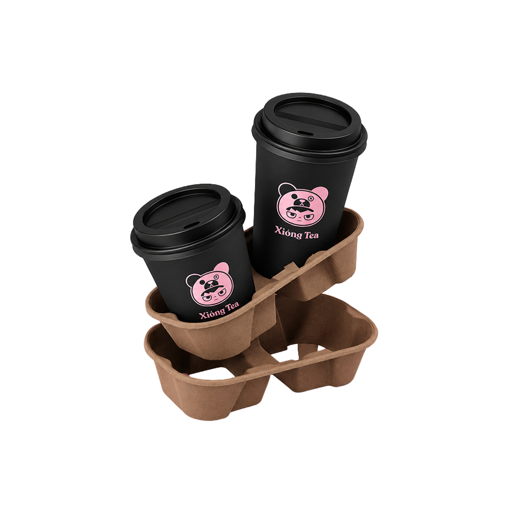 Two black disposable coffee cups with cartoon panda faces and the text 'Xiong Tea' on a pink background, placed in a brown biodegradable cup holder.