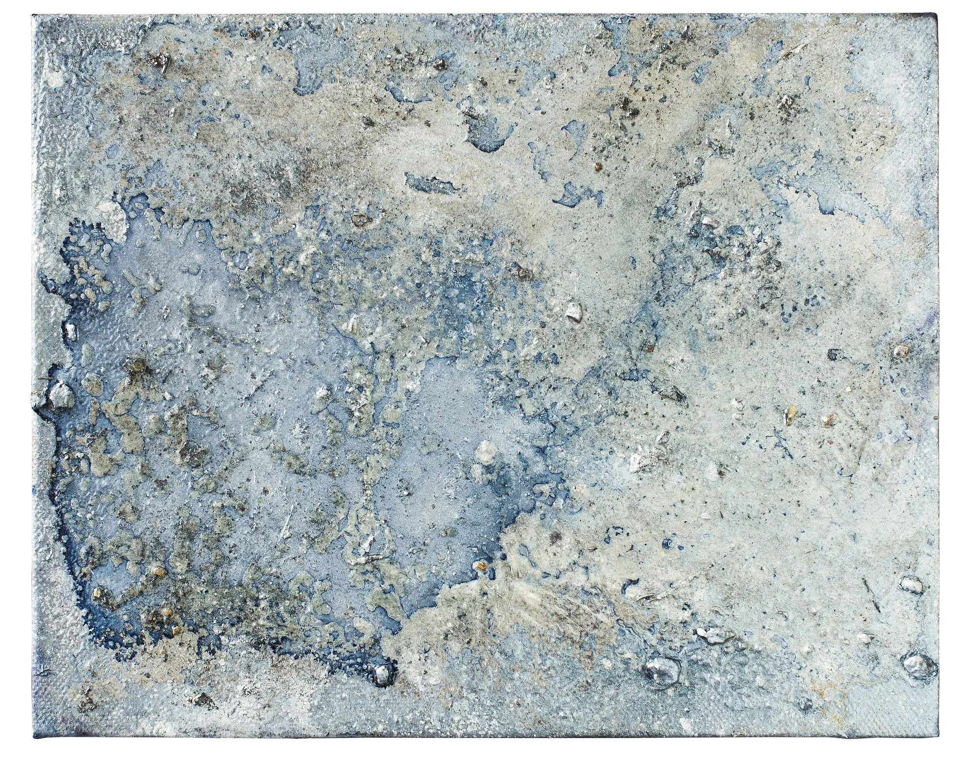 Close-up of concrete surface with cracks, pebbles, and textured patches.