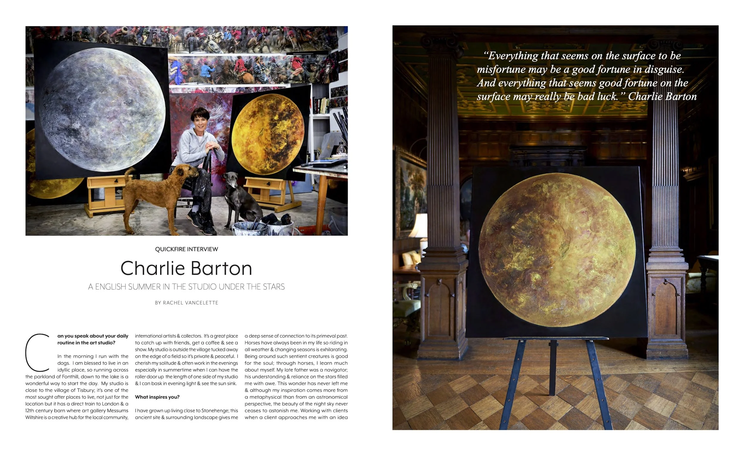An art studio with a woman sitting on a stool, accompanied by two dogs, in front of large paintings of the moon with starry backgrounds. The studio has colorful artwork on the walls and shelves with books and supplies.