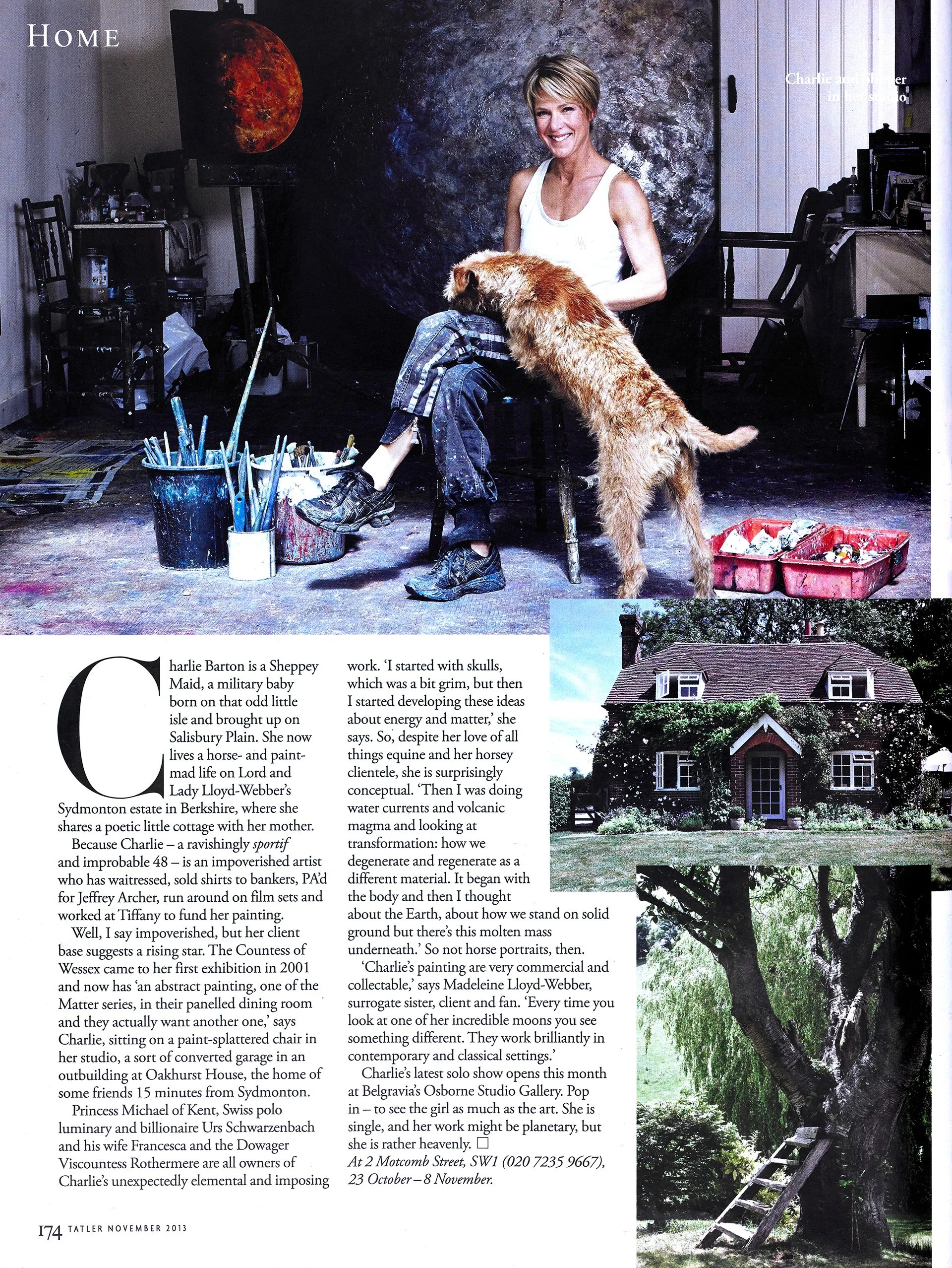 The image shows a woman sitting on a chair with a large painting of the moon and space behind her, and a golden retriever dog leaning on her. The setting appears to be an artist's studio with art supplies like paintbrushes, buckets, and canvases visi
