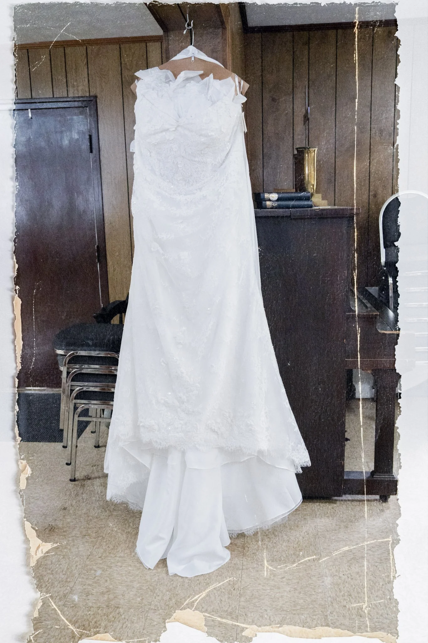 Wedding gown hanging in a rustic venue