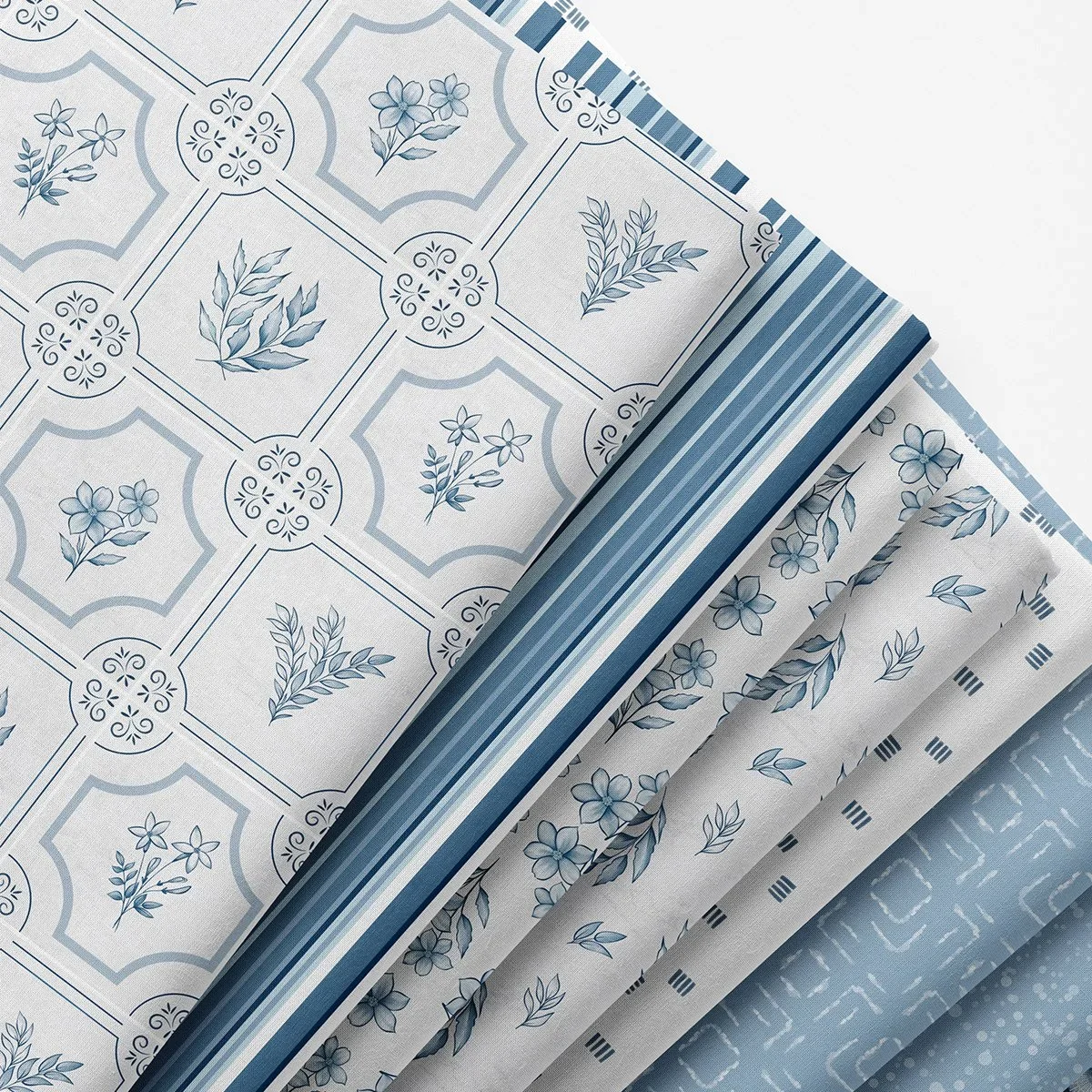 Porcelain Heirloom watercolor pattern collection by Stacie Mar on folded fabric, in Delft blue and white