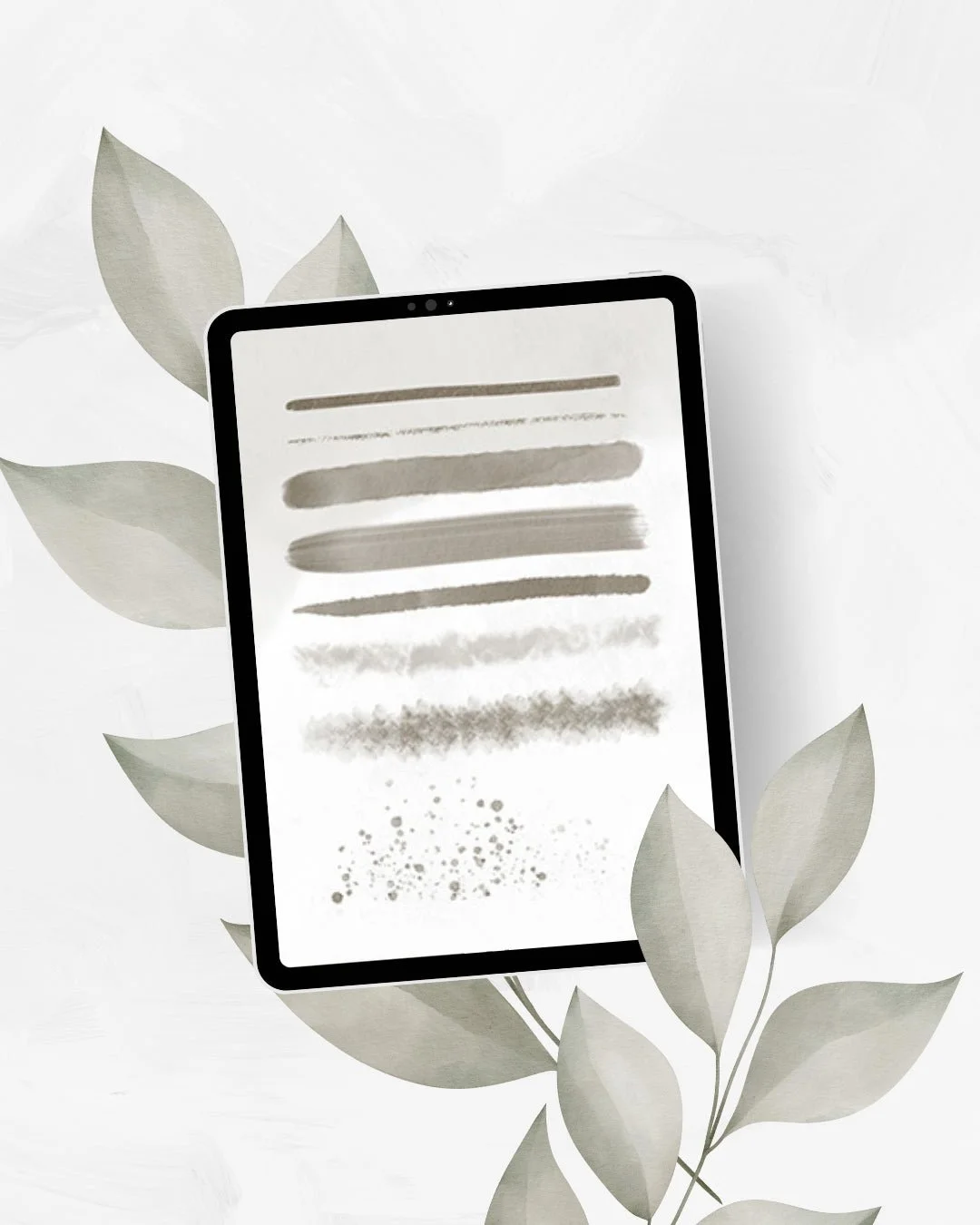 Watercolor brush strokes for Procreate on an iPad, surrounded by painted leaves